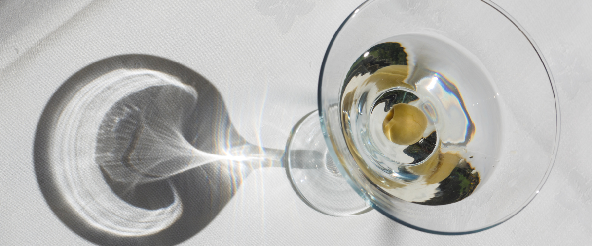 The top view of a martini with olives